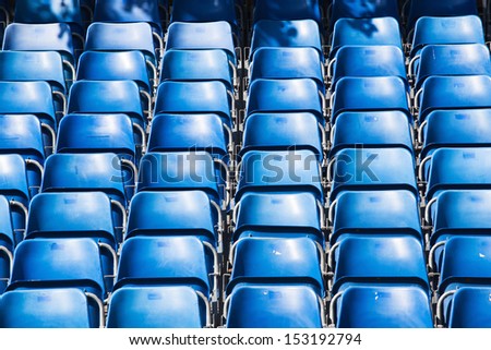 grand stand with rows of blue seats