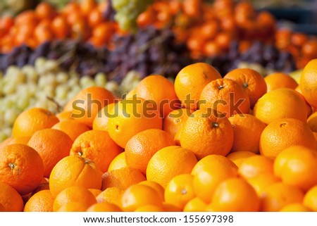 heap of oranges at a market stall
