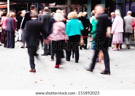 crowd of dressed up people walking to a concert