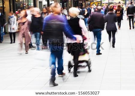 crowds of shopping people walking in the city