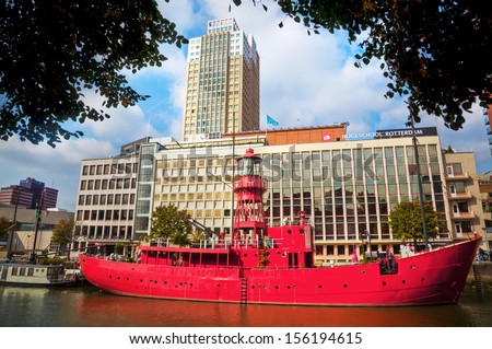 ROTTERDAM, NETHERLANDS - SEPTEMBER 21: old red ship in the Vine Harbor in front of the Rotterdam University of Applied Sciences on September 21, 2013 in Rotterdam. On the ship is today a restaurant.
