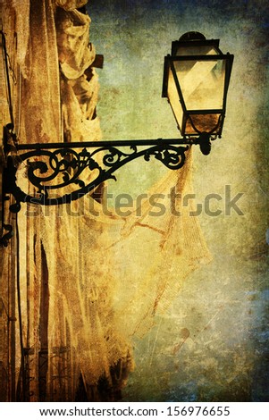 picture of an antique street lamp with a fishing net overlaid with a vintage style texture