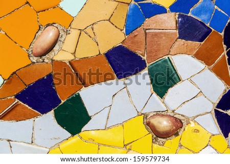 BARCELONA, SPAIN - OCTOBER 12: tile mosaic artwork in the Park Guell on October 12, 2013 in Barcelona. The park together with other works of Antoni Gaudi  is listed on the UNESCO world heritage sites.