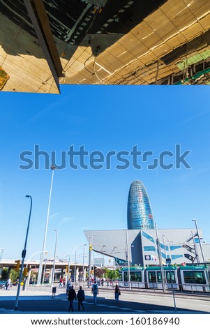 BARCELONA, SPAIN - OCTOBER 13: modern architecture on October 13, 2013 in Barcelona. view of DHUB Museu del Disseny de Barcelona and the famous Torre Agbar, above the modern ceiling of a flea market.