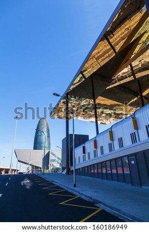BARCELONA, SPAIN - OCTOBER 13: modern architecture on October 13, 2013 in Barcelona. view of DHUB Museu del Disseny de Barcelona and the famous Torre Agbar, above the modern ceiling of a flea market.