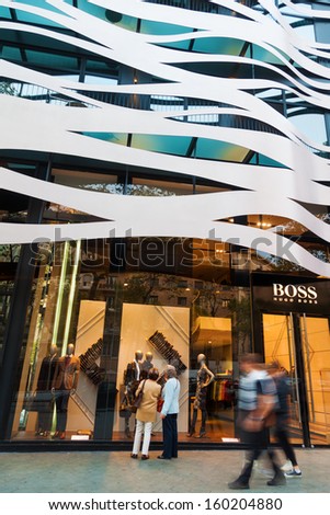 Barcelona, Spain - October 12: Boss Store With Modern House Facade And Unidentified People On October 12, 2013 In Barcelona. Hugo Boss Is A Famous Fashion Label With About 342 Stores Worldwide.
