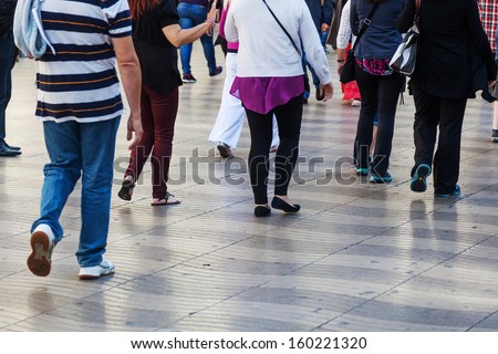crowd of people walking in the city