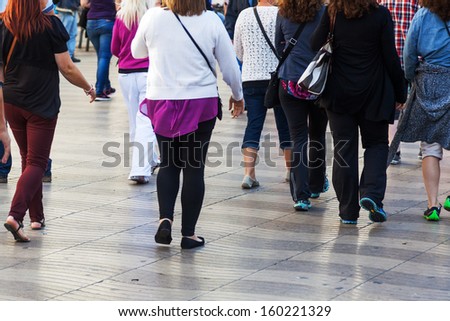crowd of people walking in the city