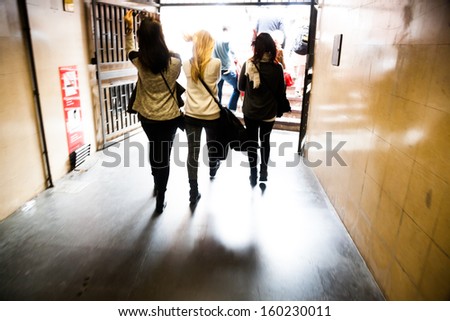 women in motion blur walking in a pedestrian tunnel
