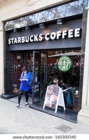 BARCELONA, SPAIN - OCTOBER 12: Starbucks Coffee store with unidentified people on October 12, 2013 in Barcelona. Starbucks is a famous American coffeehouse chain with nearly 12.000 stores in the world