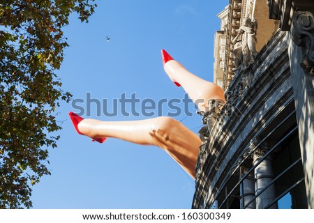 BARCELONA, SPAIN - OCTOBER 12: art installation of woman legs at the facade of the Cinema Coliseum on October 12, 2013 in Barcelona. The film theatre from 1920 is one of the biggest in Barcelon.