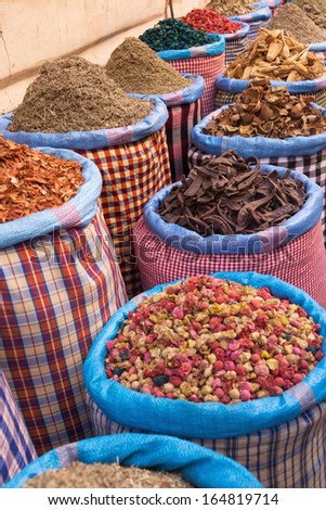 colorful spices at a market stall in the souks of Marrakesh, Morocco