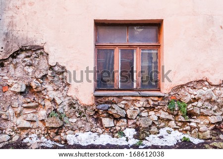 facade of a run down house with a cracked wall