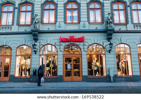 RIGA, LATVIA - DECEMBER 13, 2013: New Yorker store in an old building in the old town with unidentified man on December 13, 2013 in Riga. It is a German apparel company, 2011 existed 863 stores in Europe.