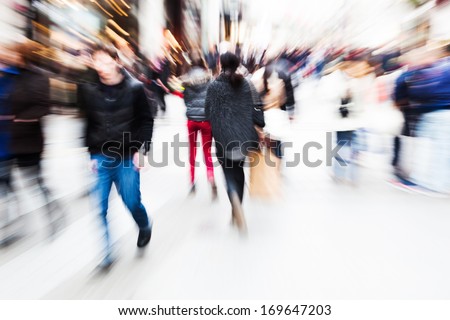 abstract zoom picture of a walking crowd in the shopping street of a city