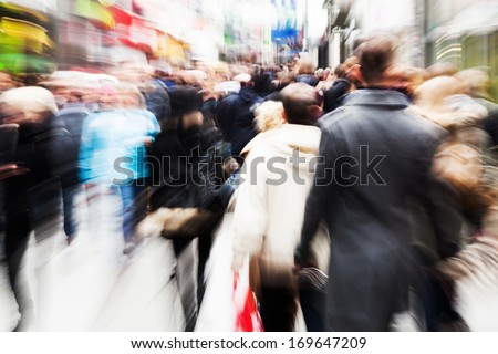 abstract motion blur picture of a walking crowd in the shopping street of a city