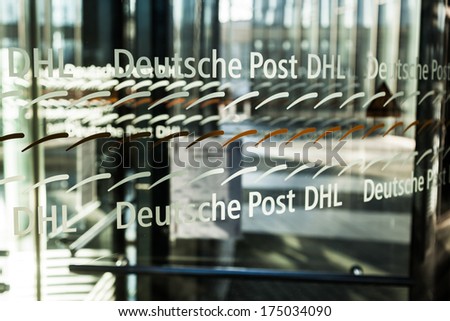 BONN, GERMANY - JANUARY 31: glass revolving door with lettering of the Post Tower on January 31, 2014 in Bonn. The Deutsche Post DHL is the largest courier company of the world.