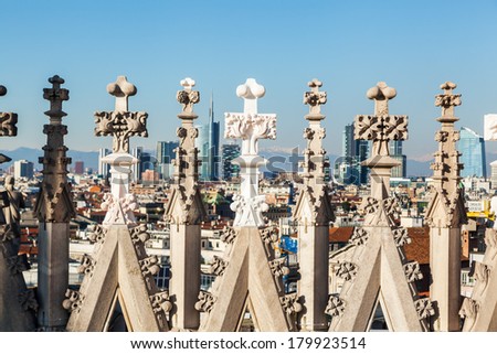 view of the Milan skyline through architectural details of the Milan Cathedral with focus on the foreground