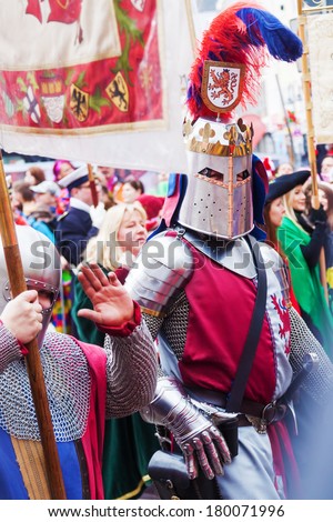 COLOGNE, GERMANY - MARCH 03: unidentfied people with men in knight\'s armor at the Rose Monday parade on March 03, 2014. The famous parade from Cologne is the German largest one.