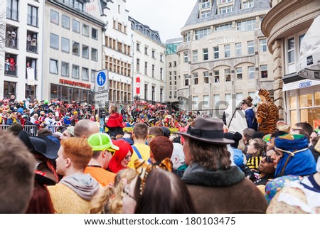 COLOGNE, GERMANY - MARCH 03, 2014: unidentified crowd of costumed spectators at the Rose Monday parade on March 03, 2014 in Cologne. The Rose Monday parade in Cologne is the largest one in Germany.