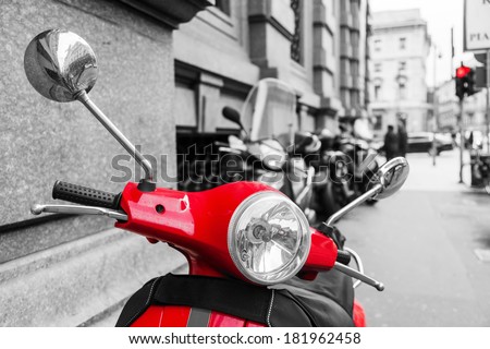 red scooter in the city of Milan with black and white surrounding