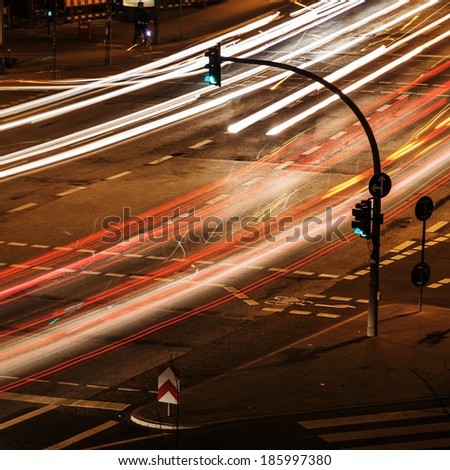 night traffic in the city with green traffic lights and light trails