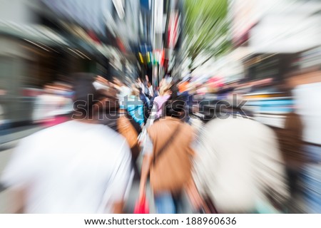 crowd of people in the shopping street of the city with creative zoom effect