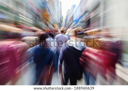 shopping crowd in the busy street of the city with creative zoom effect