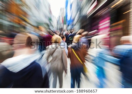 crowd of people shopping in the busy street of the city with creative zoom effect
