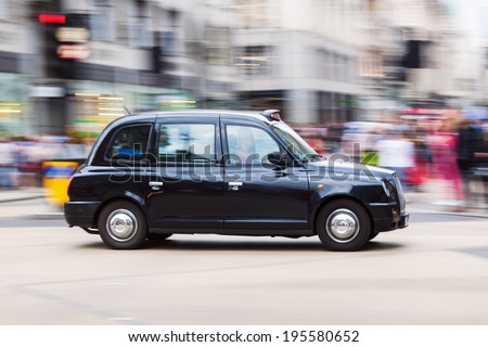 LONDON - MAY 20: traditional London Taxi in motion blur on May 20, 2014 in London. The black London Taxis are one of the world famous symbols of London.