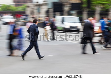 hurried businessman crossing a busy city street