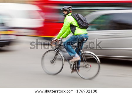 cyclists in motion blur in city traffic