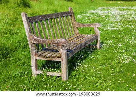 old park bench on green grass