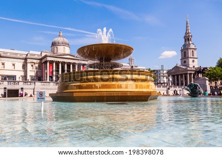 LONDON - MAY 19: fountain on the Trafalgar Square with unidentified people on May 19, 2014 in London. It is the largest public square in London and a tourist attraction.