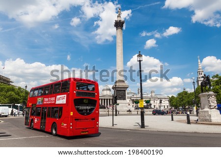 LONDON - MAY 19: red bus on the Trafalgar Square with unidentified people on May 19, 2014 in London. The historical square is the largest square in central London and a tourist attraction.