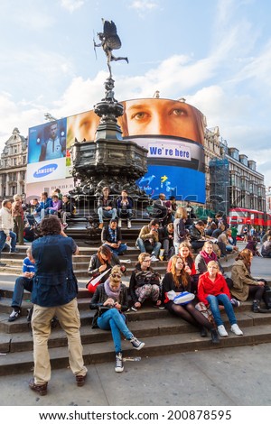 LONDON - MAY 23: Piccadilly Circus with unidentified people on May 23, 2014 in London. Its status as a major traffic junction has made Piccadilly Circus a busy meeting place and tourist attraction