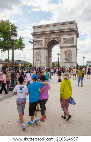 PARIS - AUGUST 03: Triumphal Arch on August 03, 2014 in Paris. Its one of the most famous monuments in Paris standing in the centre of the Place Charles de Gaulle at western end of the Champs-Elysees