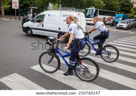 PARIS - AUGUST 04: bicycle-mounted policewomen on August 04, 2014 in Paris. Paris with over 2 mio inhabitants is the largest city in France and one of the most important cities of the western world.