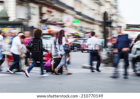 crowds of people crossing the street in the big city