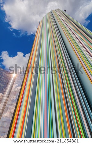 PARIS - AUGUST 05: artistic column in the district La Defense on August 05, 2014 in Paris. The 30 m high sculpture -La Cheminee- with 700 color tubes was designed by Raymond Moretti and erected 1990.
