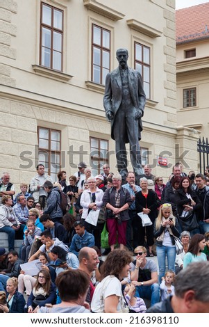 PRAGUE, CZECHIA - SEPTEMBER 03: crowds of tourists at a statue at the Prague Castle on September 03, 2014 in Prague. The Guinness Book of Records lists Prague Castle as worlds largest ancient castle