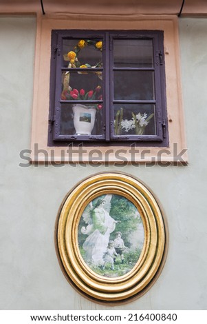PRAGUE, CZECHIA - SEPTEMBER 03: window and old picture in the Golden Lane on September 03, 2014 in Prague. Golden Lane is a tourist attraction with tiny colored houses, situated at the Prague Castle.