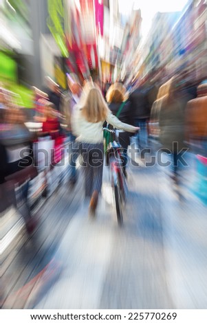 people in a pedestrian zone of the city with creative zoom effect, made by camera