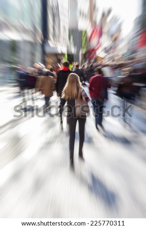 people in a pedestrian zone of the city with creative zoom effect, made by camera