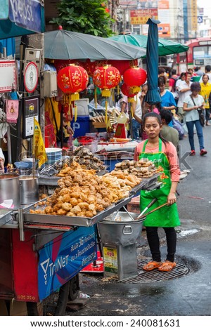 BANGKOK - DECEMBER 12: unidentified woman with a roadside food shop in Chinatown on December 12, 2014 in Bangkok. Bangkok is famous for its street food.