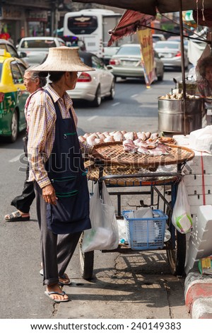 BANGKOK - DECEMBER 12: Thai woman with a roadside cook shop in Chinatown on December 12, 2014 in Bangkok, Thailand. Bangkok is famous for the street food, the city has thousands of street cook shops