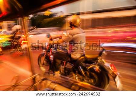 abstract motion blur picture of the night traffic in Bangkok, Thailand, seen out of a tuk tuk