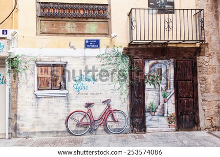 VALENCIA, SPAIN - FEBRUARY 07, 2015: mural painting in trompe l\'oeil style at the wall of a store in the old town. Trompe l\'oeil is a historical paint technique to create an optical illusion.
