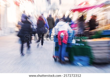 crowd of people at street market with creative zoom effect