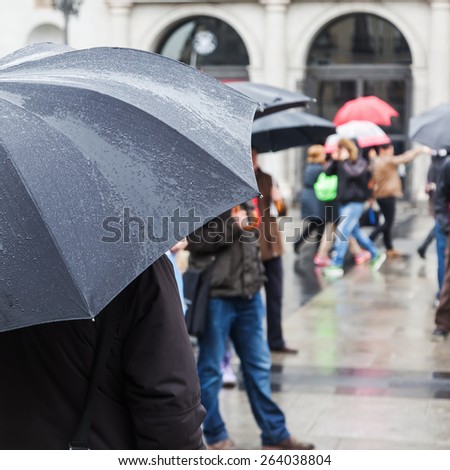 on a rainy day with rain umbrella in the city